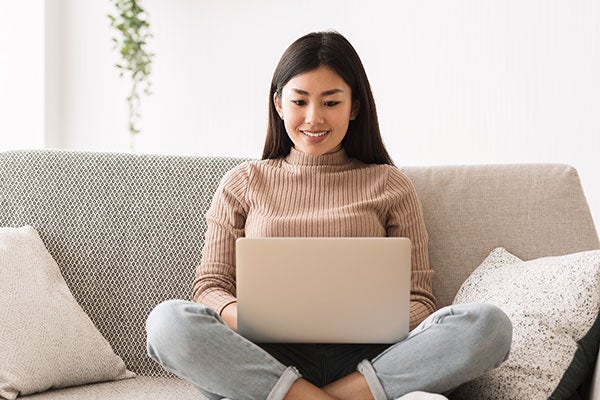 woman gazing down at computer