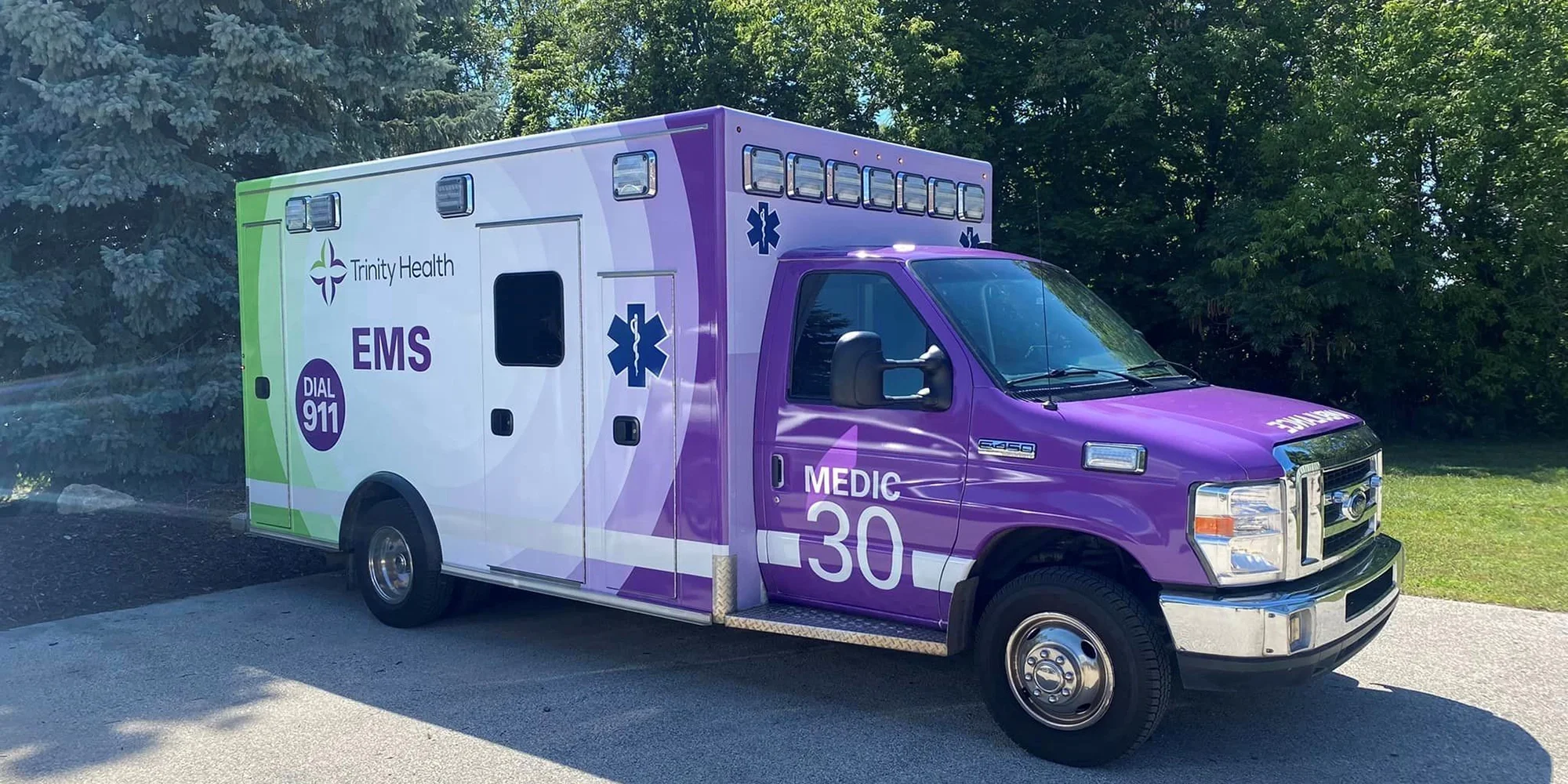 A Trinity Health-branded ambulance parked outside