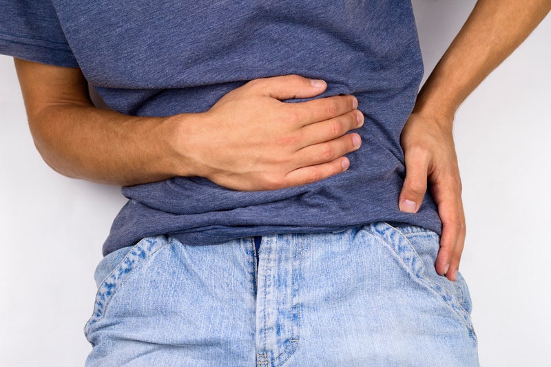 Person holding side caused by hernia pain