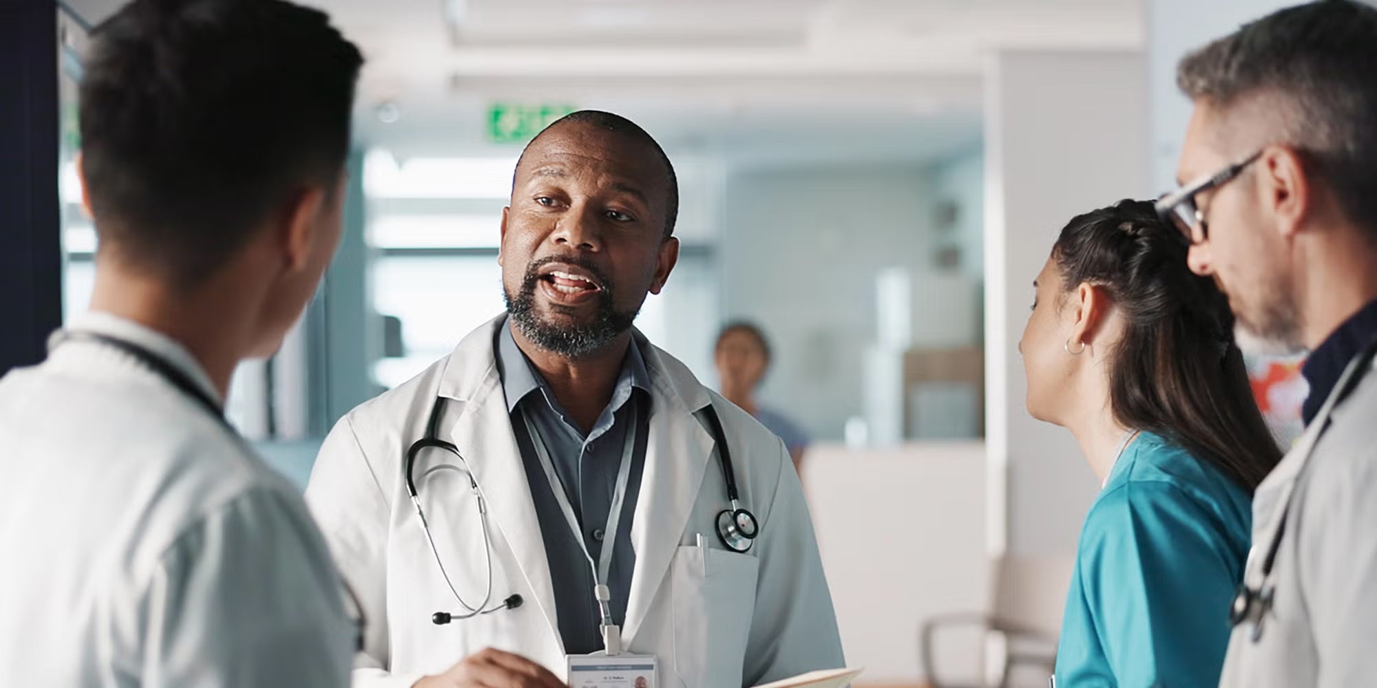 A group of providers talking in a hospital hallway