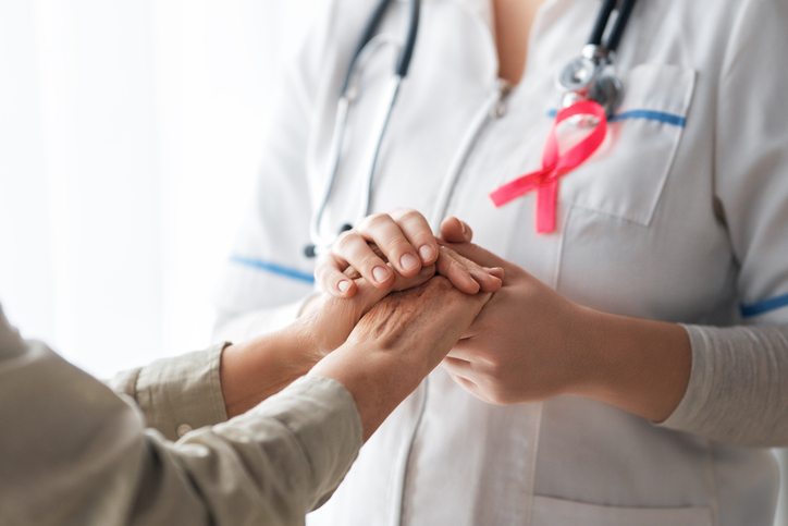 care provider holding patient's hand