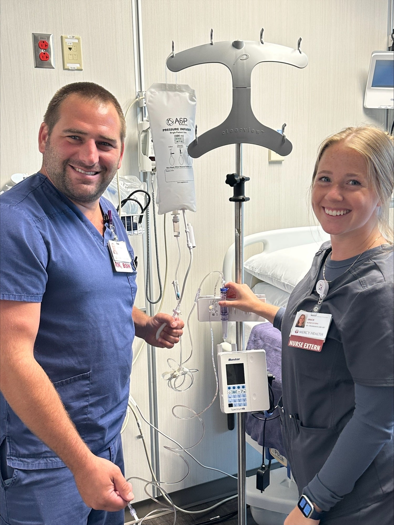 David and Rebecca standing near hospital equipment