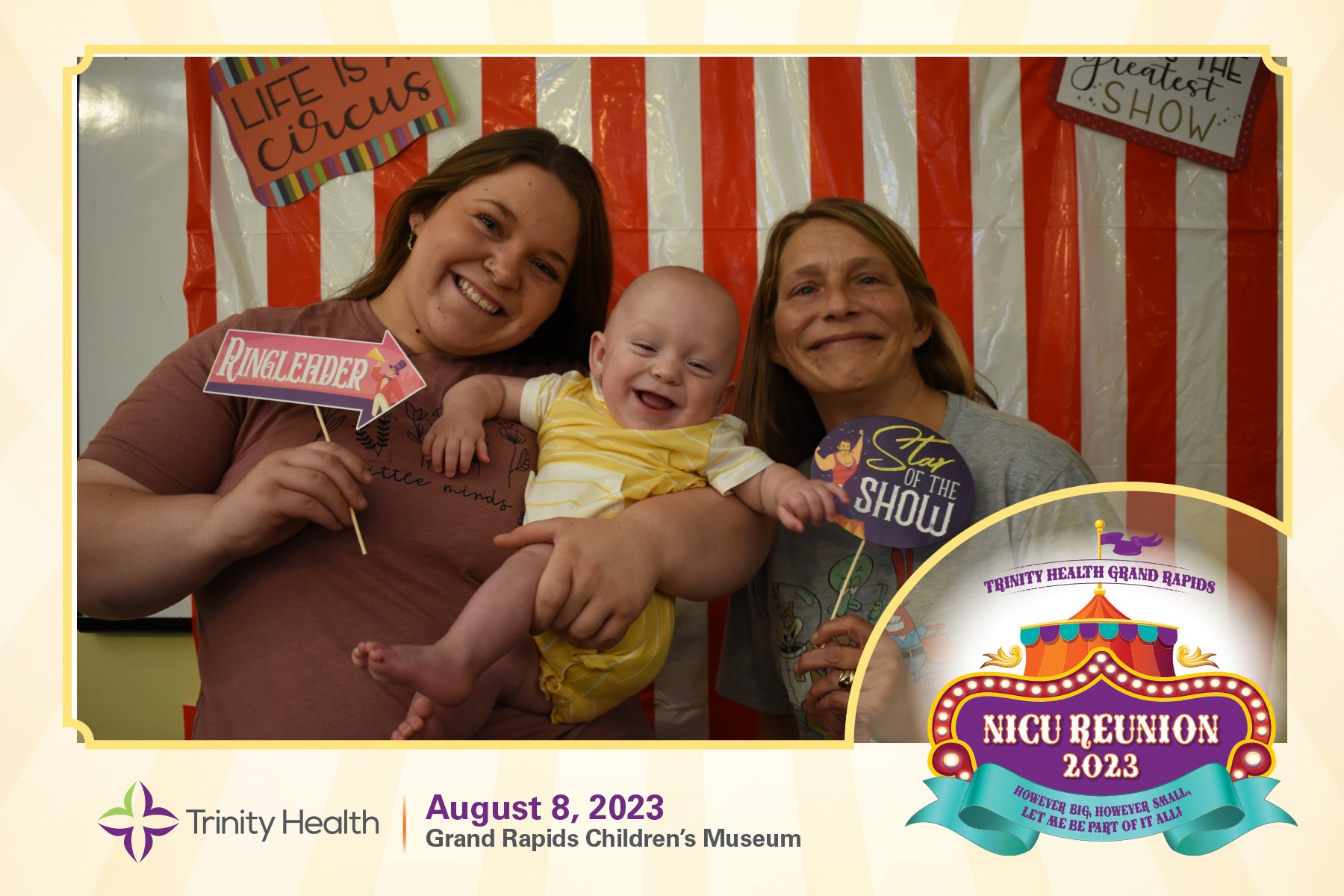 Family smiles for a photo booth at the NICU Reunion