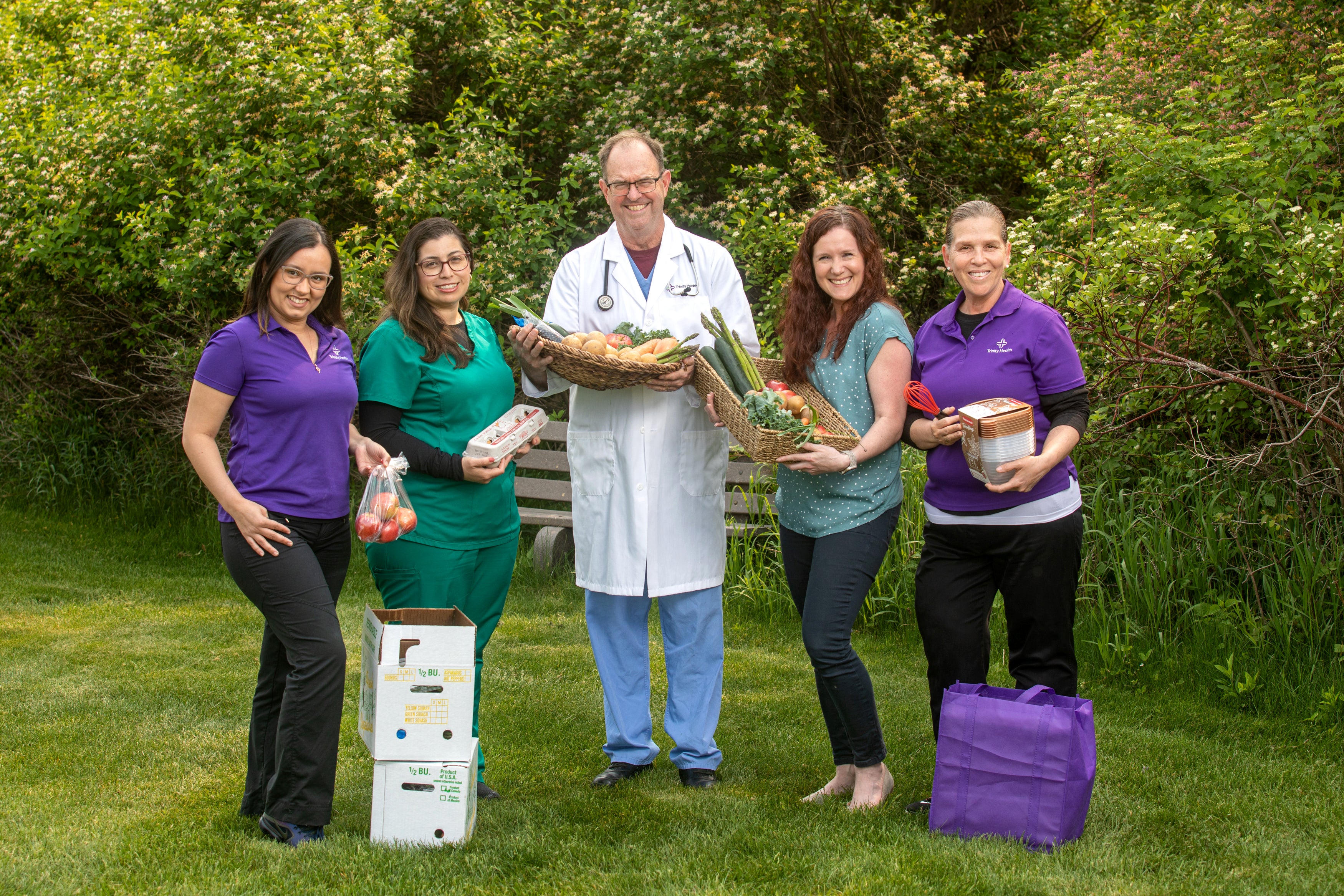 Trinity Health Medical Group - Sparta staff hold display a Healthy Food Box