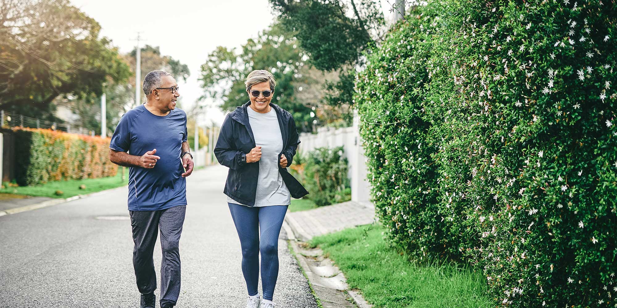 An older couple gets some exercise outside on a chilly day